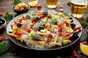 Loaded potato Vegan Fries with tomato, cucumber, olives and feta cheese