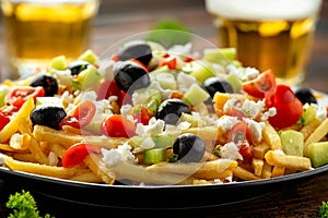 Loaded potato Vegan Fries with tomato, cucumber, olives and feta cheese