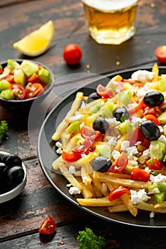 Loaded potato Vegan Fries with tomato, cucumber, olives and feta cheese