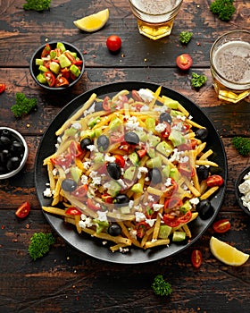 Loaded potato Vegan Fries with tomato, cucumber, olives and feta cheese