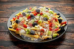 Loaded potato Vegan Fries with tomato, cucumber, olives and feta cheese