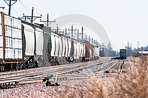 Loaded railroad cars on a siding waiting to be hauled west