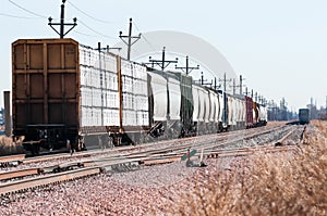 Loaded railroad cars on a siding waiting to be hauled west