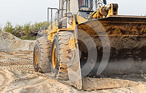 Loader bulldozer bucket. Tractor loader in the sandpit close-up view