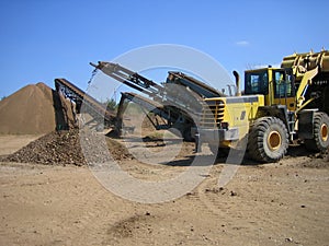 Loader and crusher at gravel pit