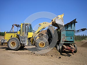 Loader and crusher at gravel pit