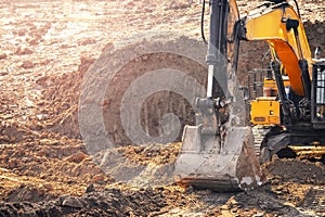 Loader excavator during earthmoving works removes overburden of soil. Concept open mine