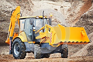 Loader excavator with risen shovel