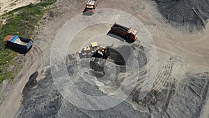 loader loads a dump truck with rubble. 4k drone footage