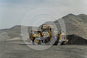 A loader loads ore into a dump truck.