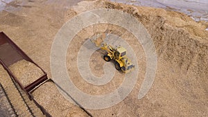 The loader loads the sawdust in the woodworking factory aerial view