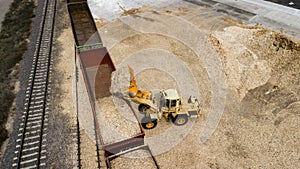 The loader loads the sawdust in the woodworking factory aerial view