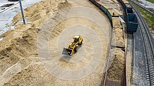 The loader loads the sawdust in the woodworking factory aerial view
