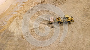 The loader loads the sawdust in the woodworking factory aerial view