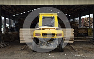 The loader transports round logs at the sawmill
