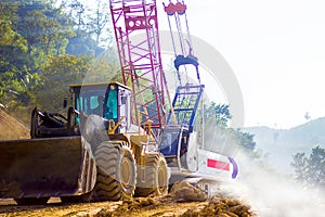 Loader truck and mobile crane is coming up hill