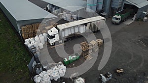 loader unloads a loaded truck. 4k drone footage