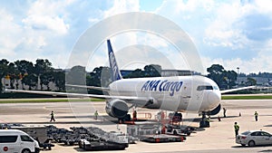 Loading of Air Japan plane ANA Cargo at Singapore Airport. International cargo.