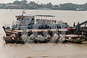 Loading a boat at the Yangon River, Myanmar photo