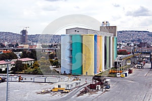 Loading cargo of cement clinker in bulk carrier by ships cranes in the port of Izmir, Turkey.