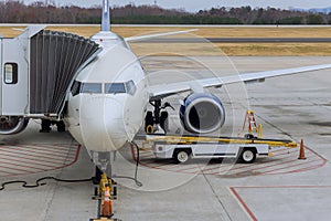 Loading of cargo containers to plane at preparing airplane before flight