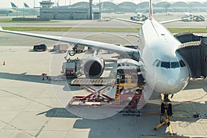 Loading cargo on plane in airport before flight.