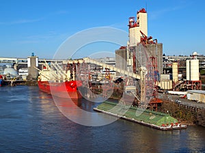 Loading a cargo ship, grain elevators Portland OR.