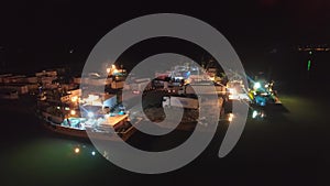 Loading from fishing ships to cargo trucks in night port