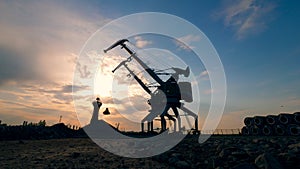 Loading machines work at docks, moving breakstones.