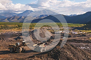 Loading of mountain soil into a dump truck bucket