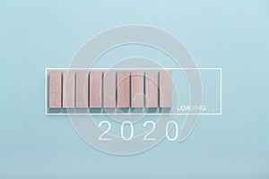 Loading new year 2020 concept , Showing loading bar with wood cube on bluebackground