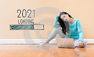 Loading new year 2021 with woman using a laptop