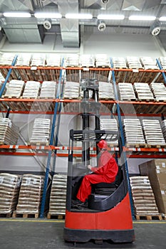 Loading sacks with forklift loader in warehouse