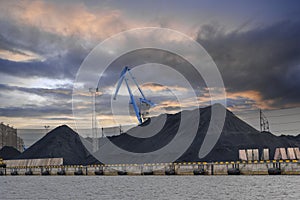 Loading and unloading of coal, railway freight cars, railway Cargo terminal, cranes. Sea cargo port, industrial background