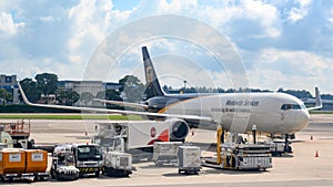 Loading of UPS - United Parcel Service - Boeing 767 Worldwide Services at Singapore Airport. International cargo.