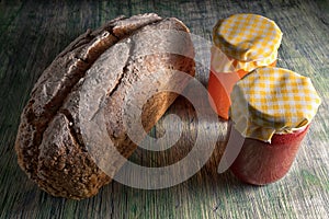 Loaf of artisan bread and jars of jam