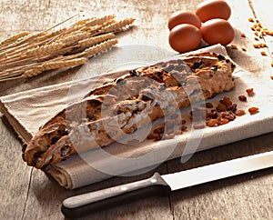 Loaf baquette of baked prunes bread on rustic ambient.