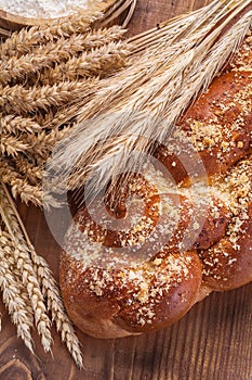 Loaf of bread and ears wheat rie on vintage board