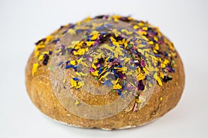 Loaf of bread with edible flowers and nuts