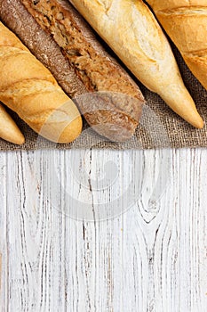 Loaf of bread on a white rustic table. baguette loaf