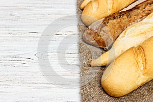 Loaf of bread on a white rustic table. baguette loaf