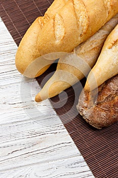 Loaf of bread on a white rustic table. baguette loaf