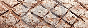 Loaf of bread on wooden background, food closeup