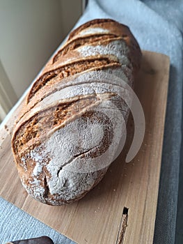 Loaf of bread on wooden board