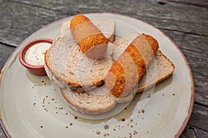 Loaf with croquettes on a plate.