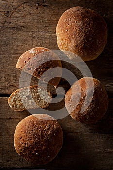 Loaf of fresh bread on a wood background