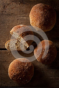 Loaf of fresh bread on a wood background