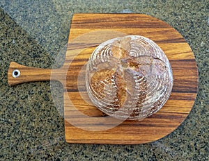 Loaf of fresh hot homemade sour dough bread out of the oven baked