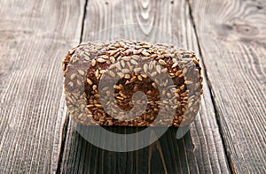 Loaf of fresh made rye multigrain bread on wooden table background