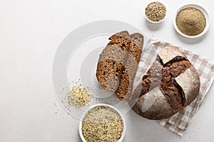 Loaf of freshly baked hemp bread and hempseeds on white background.